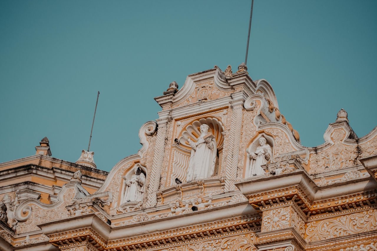 Exquisite baroque facade of La Merced Church, showcasing elaborate sculptures in Antigua, Guatemala.